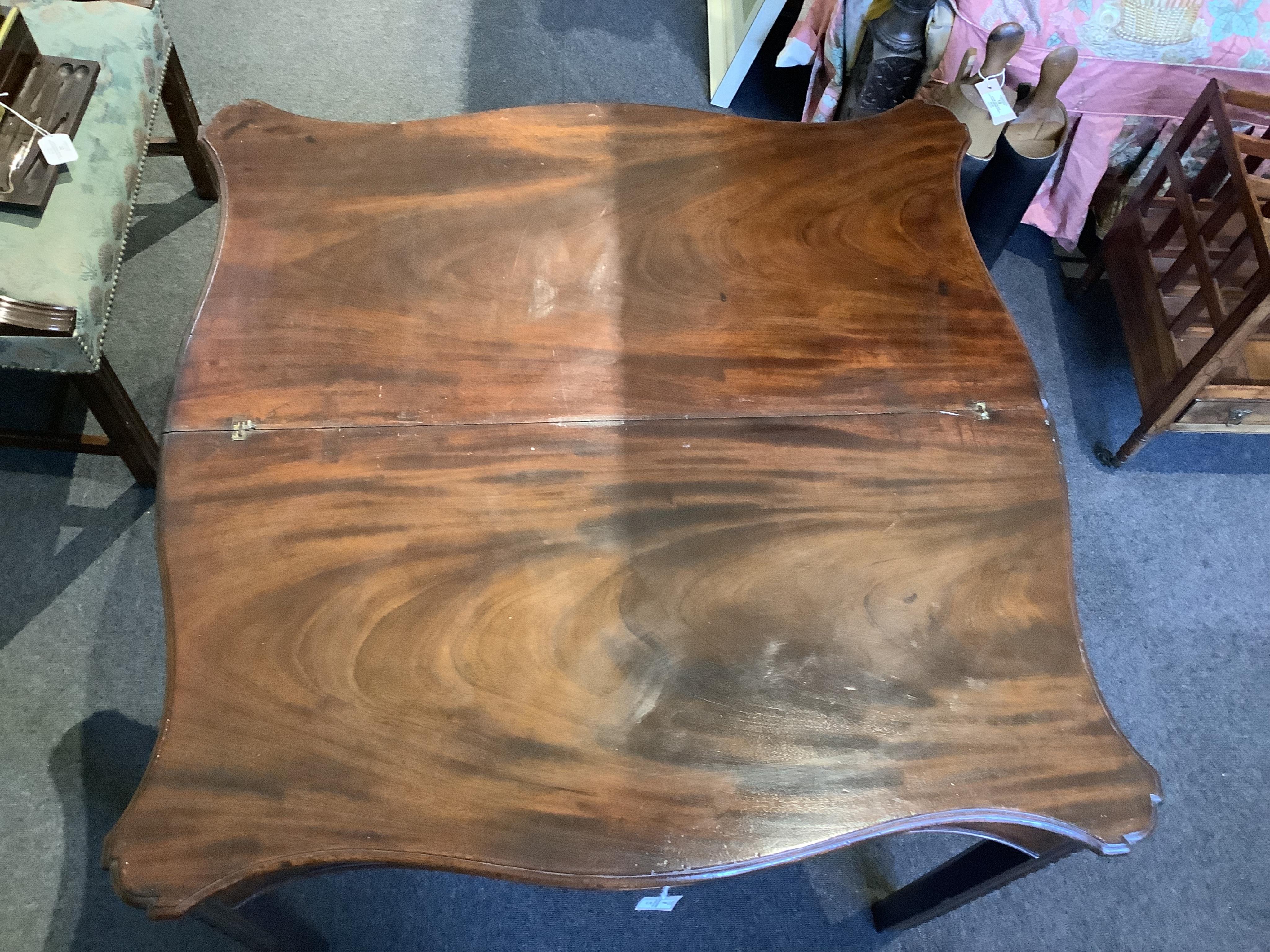 A George III serpentine mahogany tea table